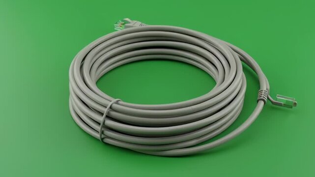 Rolled Ethernet Cable with RJ45 Connectors on a Solid Green Background