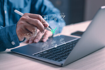 concept of certification and quality assurance, business people work with computer using a pen to check boxes to approve certifications according to standards, or manage documents on a virtual screen