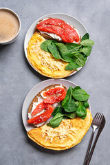 Healthy breakfast for two. Omelette, sandwich with salmon, spinach.