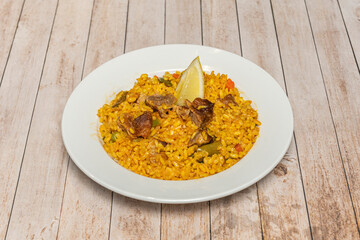 aerial view of a mixed paella with seafood and chicken, showing the orderly arrangement of the ingredients before mixing them for serving