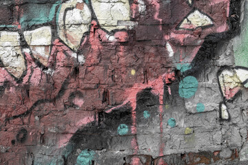 Abstraction of crumbling graffiti on a city street wall. Colorful abstract background. Old, cracked, peeling paint on the wall as a background.