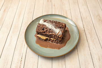 White chocolate and raspberry tart with a white chocolate sponge, a raspberry cream filling, and a white chocolate topping with fresh raspberries