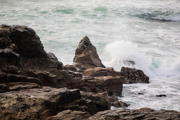 Waves crashing on the rocks at Godrevy Beach in Cornwall UK.