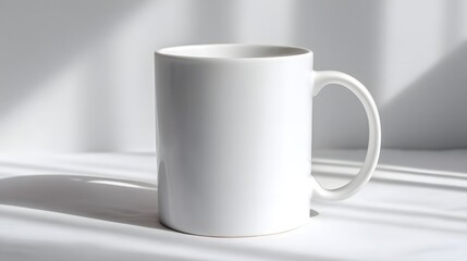 Obraz premium Plain White Ceramic Mug on a White Surface with Shadow Play.