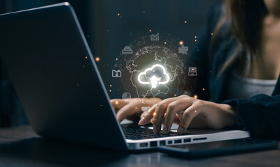 A professional works on a laptop with a global cloud upload icon, representing cloud computing, data storage, file sharing, remote access, and modern IT infrastructure.