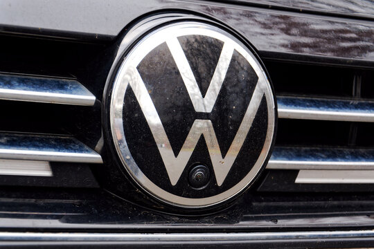 New Volkswagen company logo on car on cloudy winter day with dirty streets on December 7, 2025 in Prague, Czech Republic.