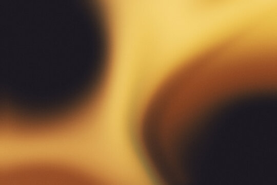 Golden amber and warm glow grainy gradient blur background. Cinematic luxury abstract background.