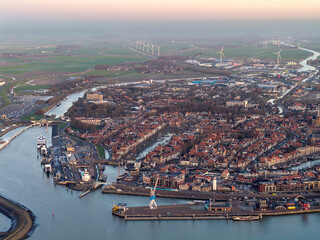 Naklejka premium Aerial drone view of Harlingen city centre and harbour at sunset 