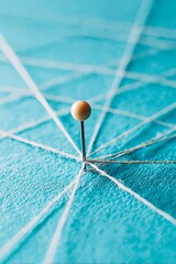 Pin connected by threads with a blue background