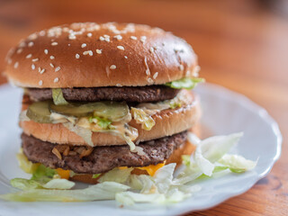 Double Layer Beef Hamburger on a Plate with Fresh Lettuce