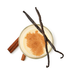 Delicious protein shake in glass, cinnamon and vanilla pods isolated on white, top view
