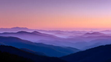 Fototapeta premium Layered mountain ridges fade into a pastel-colored twilight sky