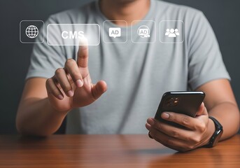 Person using a smartphone and touching a cms icon with other icons above a wooden table surface