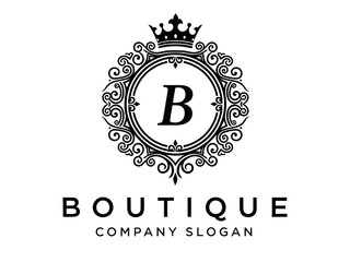 Naklejka premium Elegant boutique logo with crown and ornate design elements