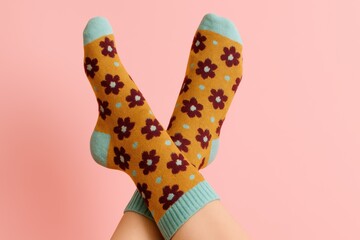 Playful floral patterned socks on pink background lifestyle fashion studio close-up comfort