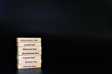 Fototapeta premium Faithfulness Living Wooden Block Stack Black Background