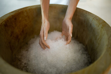 Close up picture of female hands holding spa salt