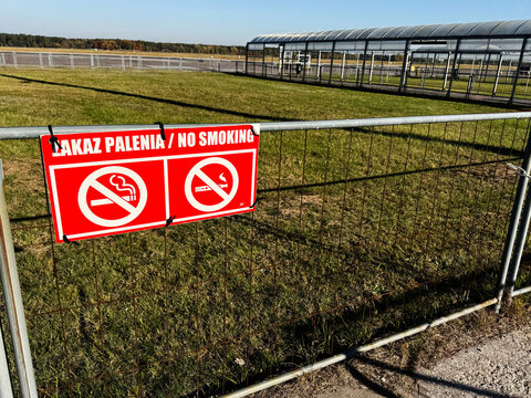 No smoking sign on fence at Warsaw Modlin Airport outskirts in Nowy Dwor Mazowiecki Poland