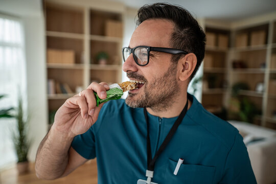 Healthcare worker eating healthy protein bar snack