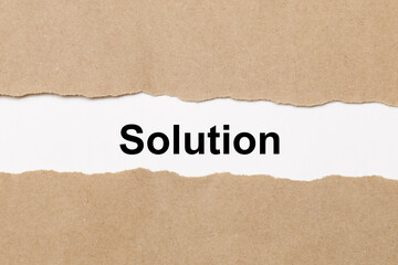 Torn paper revealing solution text symbolizing problem solving, business strategy, innovation and finding answers for challenges in management and marketing