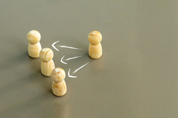 Wooden figures connected by arrows representing teamwork, communication flow, leadership and collaboration concept in business and social relationships