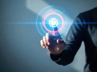 A persons hand touching a glowing blue and pink target on a gray background