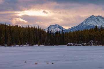 Sunrise Clouds Over A Frozen Mountain Lake