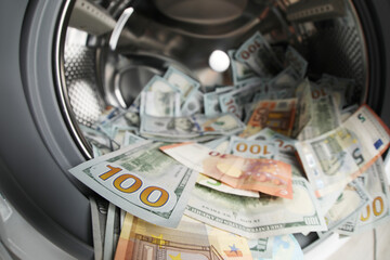 Money in washing machine drum, closeup view