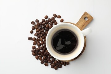 Cup of aromatic coffee and roasted beans on white background, flat lay