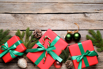 Christmas gifts and festive decor on wooden table, flat lay. Space for text