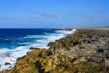 Wild and rugged rocky coastline of with crashing waves on the leeward coast of Bonaire in the Washington-Slagbaai National Park
