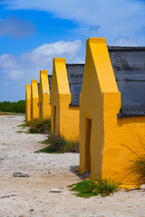 Historic red Slave Huts (Slave Houses) on the Salt Flats Coast of Bonaire in the Dutch Caribbean