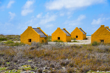 Historic red Slave Huts (Slave Houses) on the Salt Flats Coast of Bonaire in the Dutch Caribbean