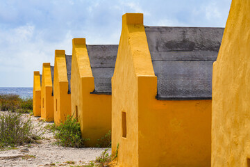 Historic red Slave Huts (Slave Houses) on the Salt Flats Coast of Bonaire in the Dutch Caribbean