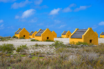 Historic red Slave Huts (Slave Houses) on the Salt Flats Coast of Bonaire in the Dutch Caribbean