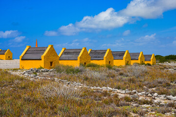 Historic red Slave Huts (Slave Houses) on the Salt Flats Coast of Bonaire in the Dutch Caribbean
