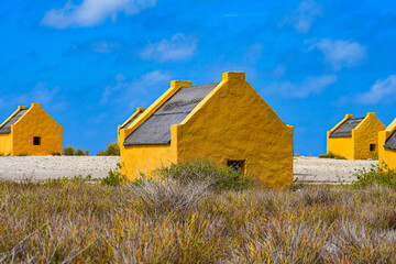 Historic red Slave Huts (Slave Houses) on the Salt Flats Coast of Bonaire in the Dutch Caribbean