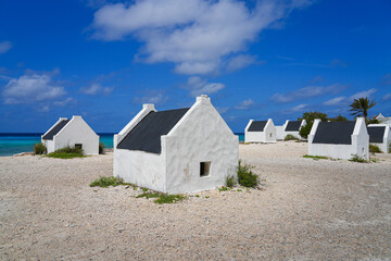 Historic white Slave Huts (Slave Houses) on the Salt Flats Coast of Bonaire in the Dutch Caribbean