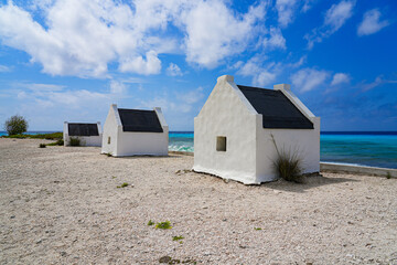 Historic white Slave Huts (Slave Houses) on the Salt Flats Coast of Bonaire in the Dutch Caribbean