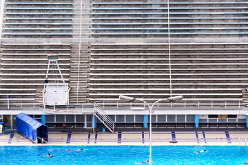 Obraz premium Unrecognizable people swimming in beautiful outdoors public pool, Podoli swimming complex, Prague, Czech republic