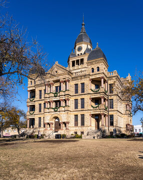 Ornate stone courthouse building in the central downtown square of Denton in Texas