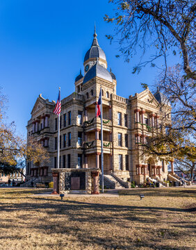 Ornate stone courthouse building in the central downtown square of Denton in Texas