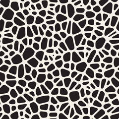 Vector seamless organic pattern. Abstract pattern with irregular black shapes resembling stones or pebbles on a white background, creating a textured, organic look.