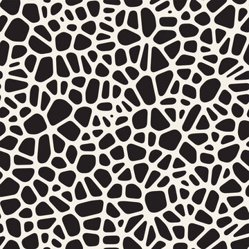 Vector seamless organic pattern. Abstract pattern with irregular black shapes resembling stones or pebbles on a white background, creating a textured, organic look.