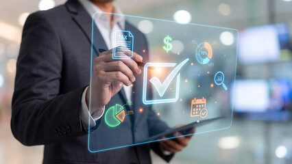 Caucasian adult in suit uses stylus on transparent screen with icons for tax, charts, cash, and tasks. A modern moment of finance and planning, ideal for business, tech, or analytics content.