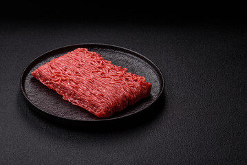Raw ground beef or pork for burgers or meatballs with salt and spices. Raw ground beef