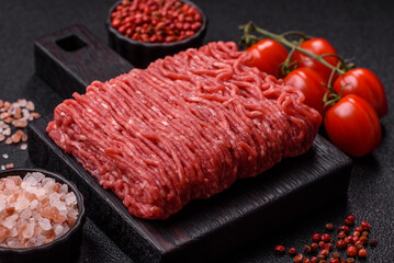 Raw ground beef or pork for burgers or meatballs with salt and spices. Raw ground beef