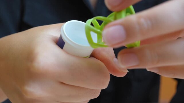 Close-up of female hands opening a plastic tube of effervescent vitamin c tablets to boost her immune system, demonstrating a healthy lifestyle and the use of dietary supplements