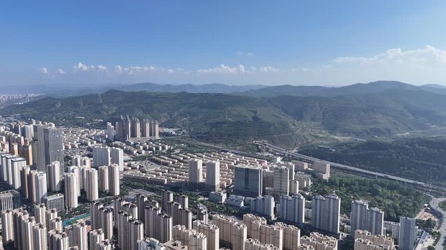 Xining City Aerial Skyline Shot with Mountains and Blue Sky