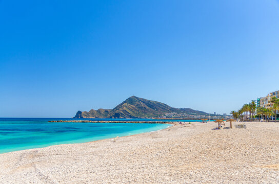 Pebbe beach in Altea town on Costa Blanca coast, mountain Sierra Helada natural park, coastline Altea bay Mediterranean Sea with azure turquoise water in sunny summer day, Alicante province, Spain